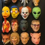 A retail display wall of Halloween masks