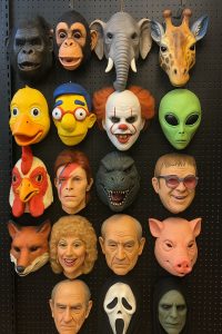 A retail display wall of Halloween masks